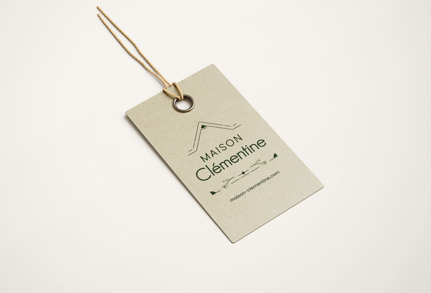 Étiquette de transport en carton kraft avec le logo Maison Clémentine en vert et l'adresse du site